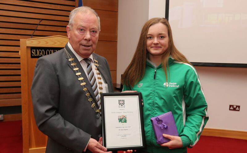 Cathaoirleach Seamus Kilgannon making a presentation to Mona McSharry