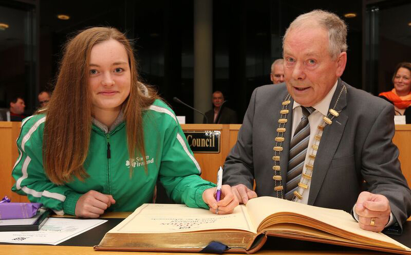 Mona McSharry signing the Distinguished Visitors Book